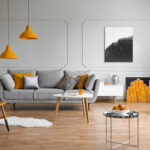 orange accents in a grey living room interior